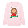 Front view of a pink children’s Christmas sweatshirt by Fefus Designs, featuring an illustrated biracial girl with curly hair wearing a red dress decorated with festive holly. Made from soft cotton fabric with ribbed collar, cuffs, and hem for warmth and comfort, celebrating diversity and inclusivity.