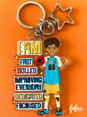 Double-sided Biracial Boy Footballer keychain made from clear acrylic. Perfect for young athletes to show their love for football and celebrate diversity. (63.5mm diameter)